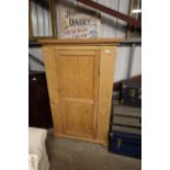 A stripped pine cupboard