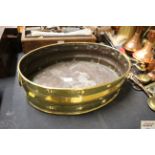 An antique brass twin handled oval jardiniere