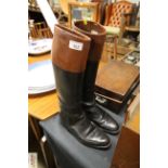 A pair of vintage black and tan leather riding boo