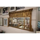 An antique gilt framed triple chimney mirror