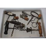A box containing corkscrews, bottle pourers and st