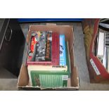 A box containing various car manuals and books etc