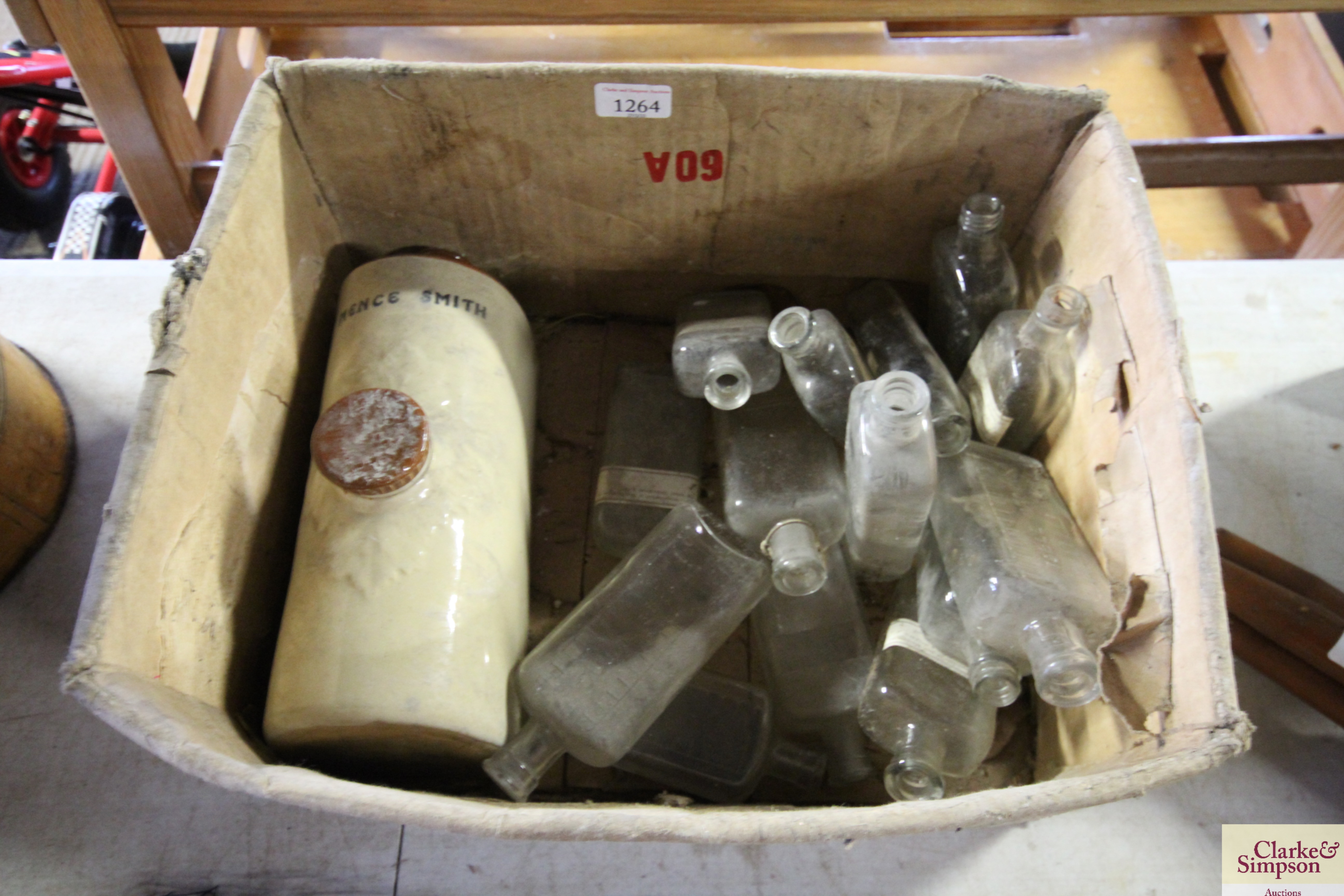 A quantity of vintage glass bottles and a stonewar