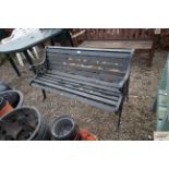 A black painted wooden and metal garden bench