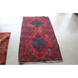 An approximately 4'9" x 2'9" Bolochi rug