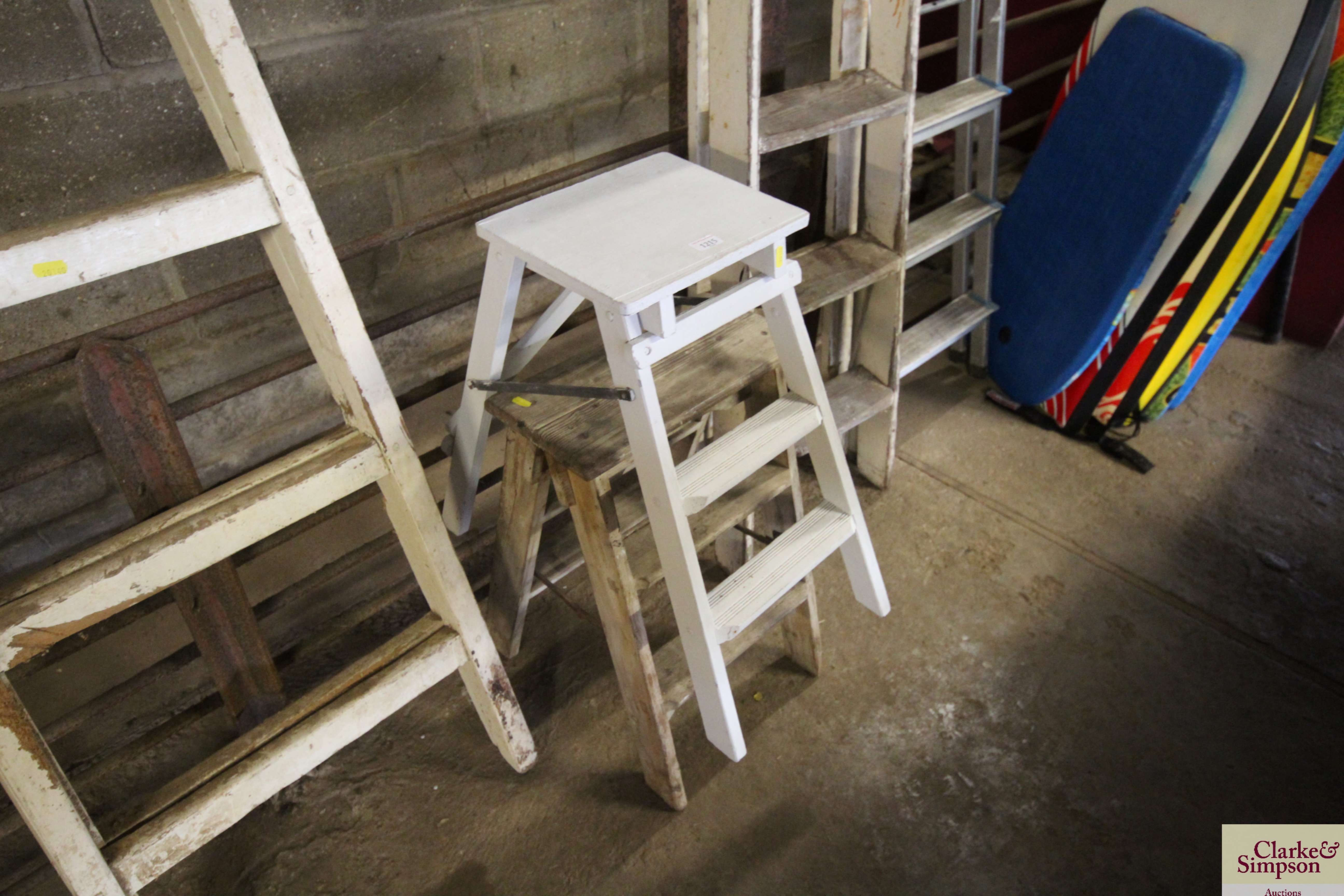 Two small sets of wooden folding steps