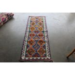 An approximately 5'9" x 2'1" Chobi Kelim rug