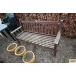 A varnished wooden garden bench