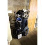 Two golf bags with a quantity of clubs