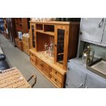 A continental pine and glazed entertainment unit A