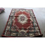 An approximately 7'5" x 5'3" floral patterned rug