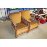 A pair of oak framed and upholstered armchairs