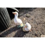 Two concrete garden ornaments in the form of ducks