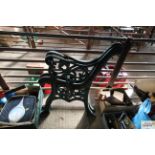 A pair of green painted cast iron bench ends