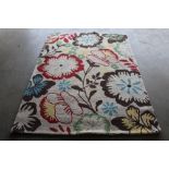 An approx. 6'10" x 5' floral wool rug