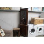 A reproduction mahogany corner cabinet together wi