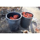 Two plastic dustbins containing a large quantity o