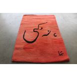 An approx. 6' x 4'1" red and black patterned rug