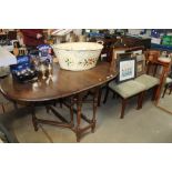 An oak gate leg table together with four chairs