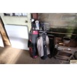 Two golf bags and contents to include drivers; iro