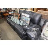 A black upholstered three seater reclining sofa