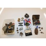 A collection of military cap badges, buttons etc