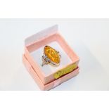 A large sterling silver and amber ring, size O