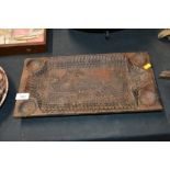 An unusual carved wooden platter decorated with wi