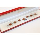 A sterling silver and amber bracelet