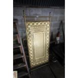 A decorative brass double headboard/panel