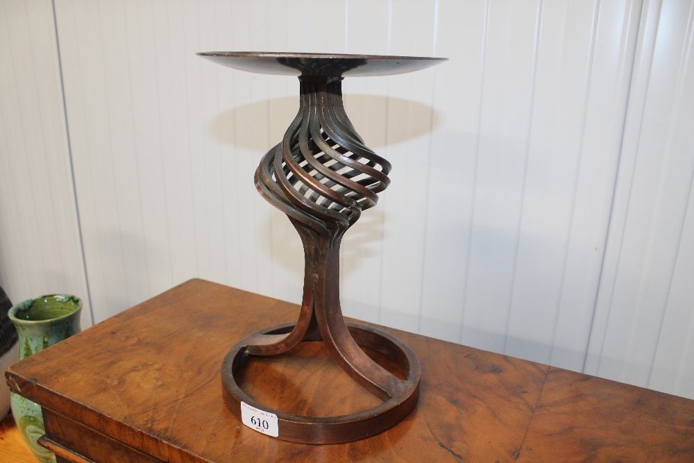 A copper candle holder