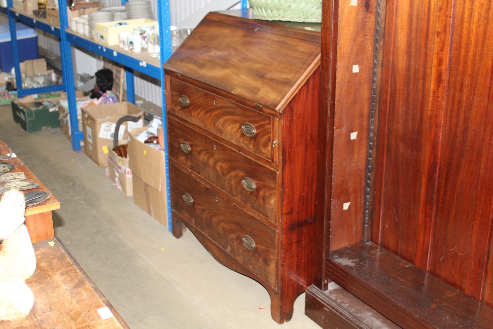 A Georgian bureau fitted three long drawers