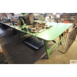 A large green painted trestle table measuring appr