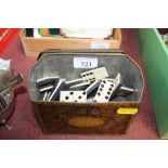 A vintage biscuit tin and contents of dominoes