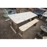 A pine outdoor table and two benches