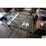 A large glass topped metal framed coffee table mea