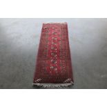 An approx. 4'8" x 1'9" red  patterned Eastern runner