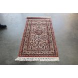 An approx. 5'8" x 2'8" floral patterned rug