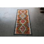 An approx. 4'9" x 2'1" Chobi Kilim rug