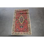 An approx. 3'8" x 2' floral wool rug