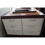 A pair of wood effect three drawer bedside chests