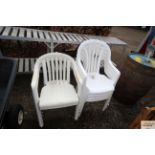 Four white plastic garden chairs and two similar