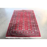 An approx. 6'6" x 4'2" Eastern patterned red Bolchara rug