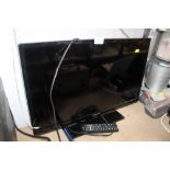 A Panasonic flat screen television with remote con