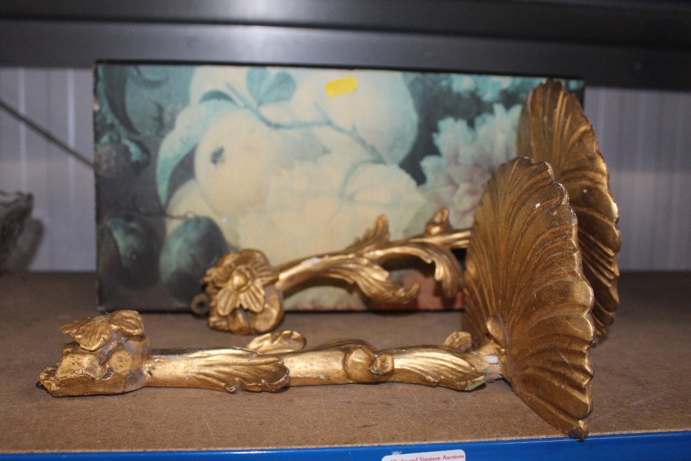 A pair of gilt wall brackets together with a flora