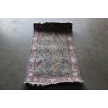 An approx. 4'x 2'5" Eastern patterned silk rug with bird and deer decoration