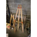 A child's Tri-ang wooden folding artists easel and another larger similar