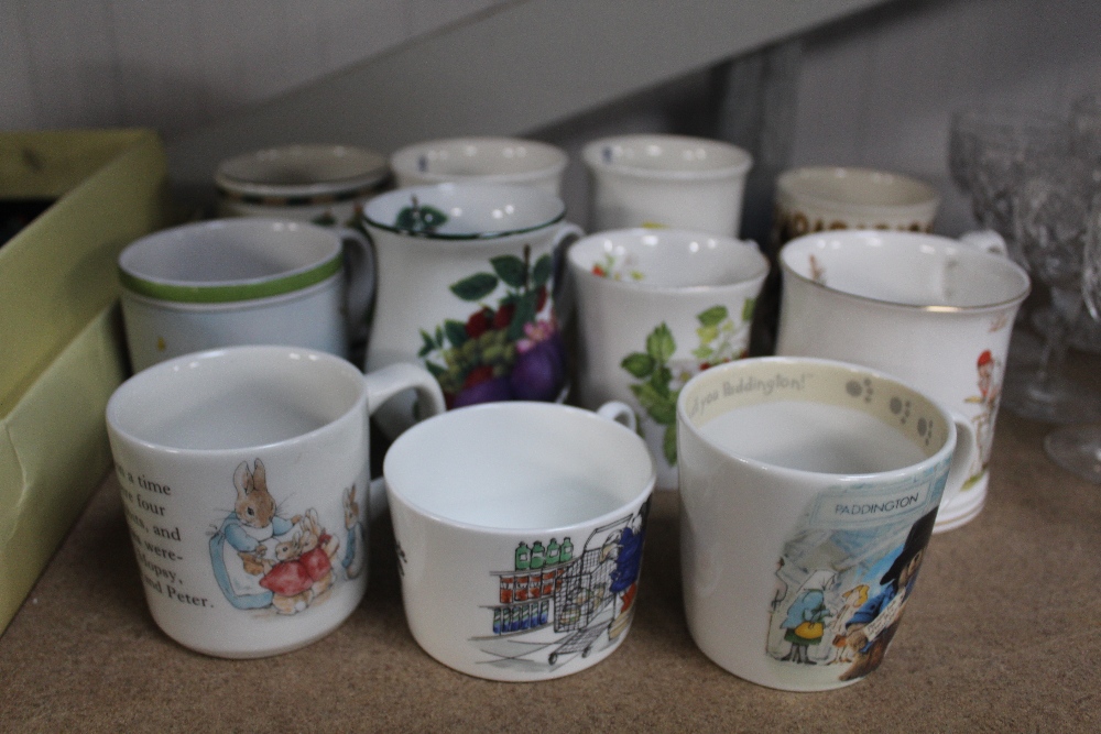 A quantity of mugs to include Peter Rabbit, Wedgwo