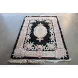 An approx. 6'8" x 4'2" Chinese wool rug