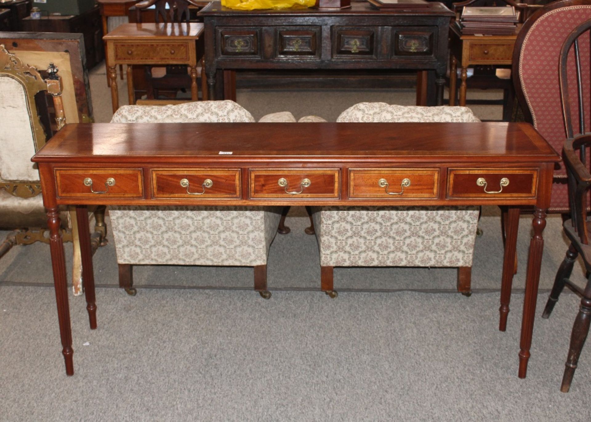 A mahogany and satinwood cross banded five drawer